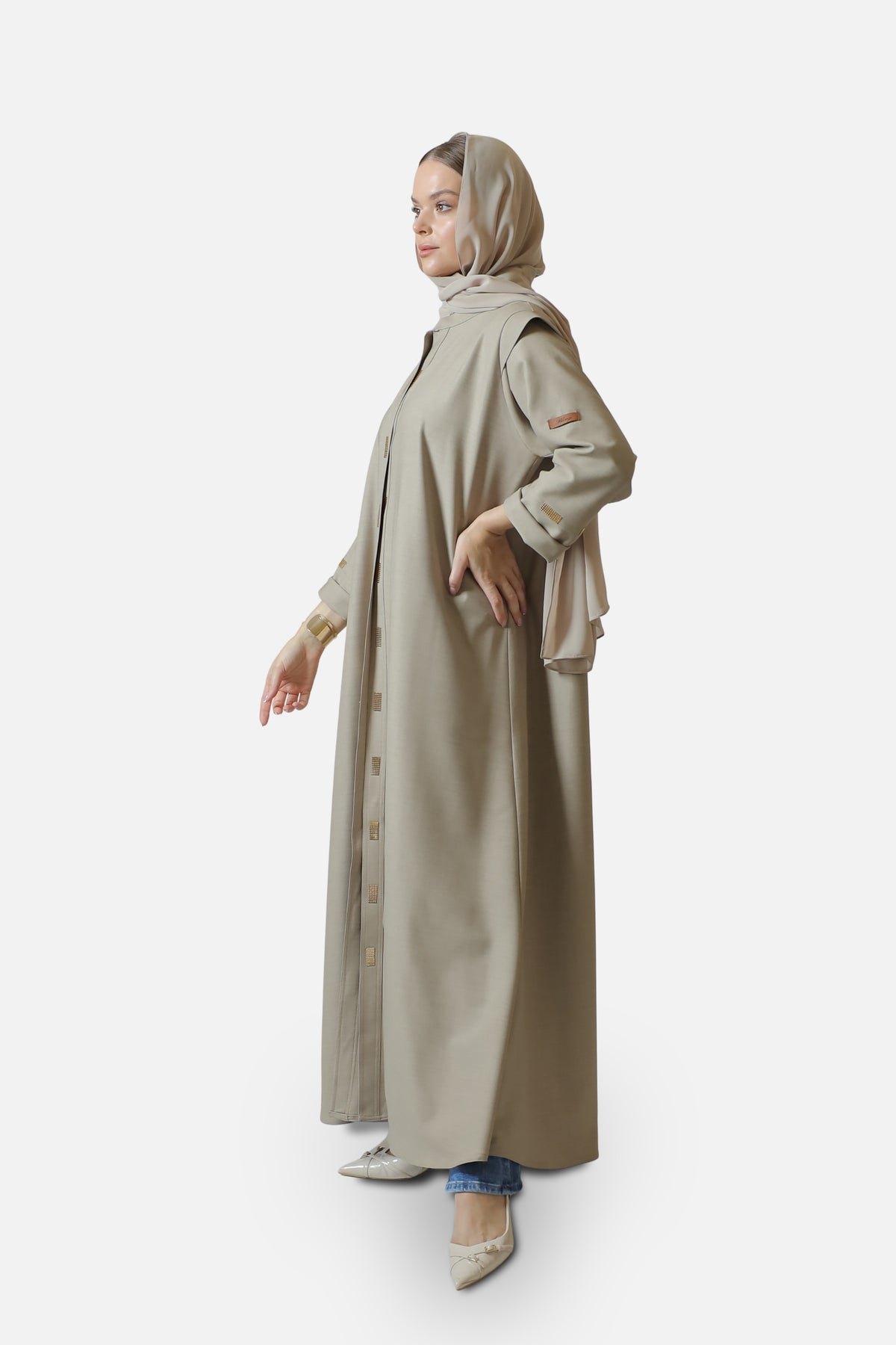 Beige cotton abaya with gold-tone details — full-length side view