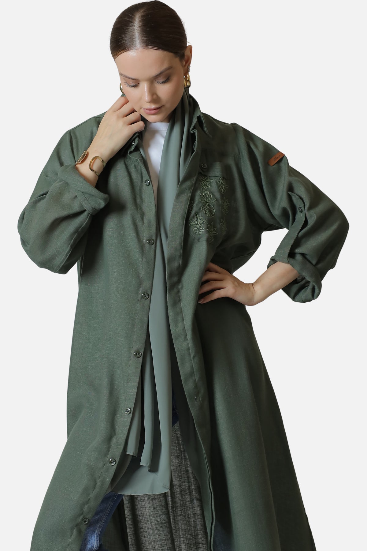 Green linen abaya with tonal embroidery details — front view