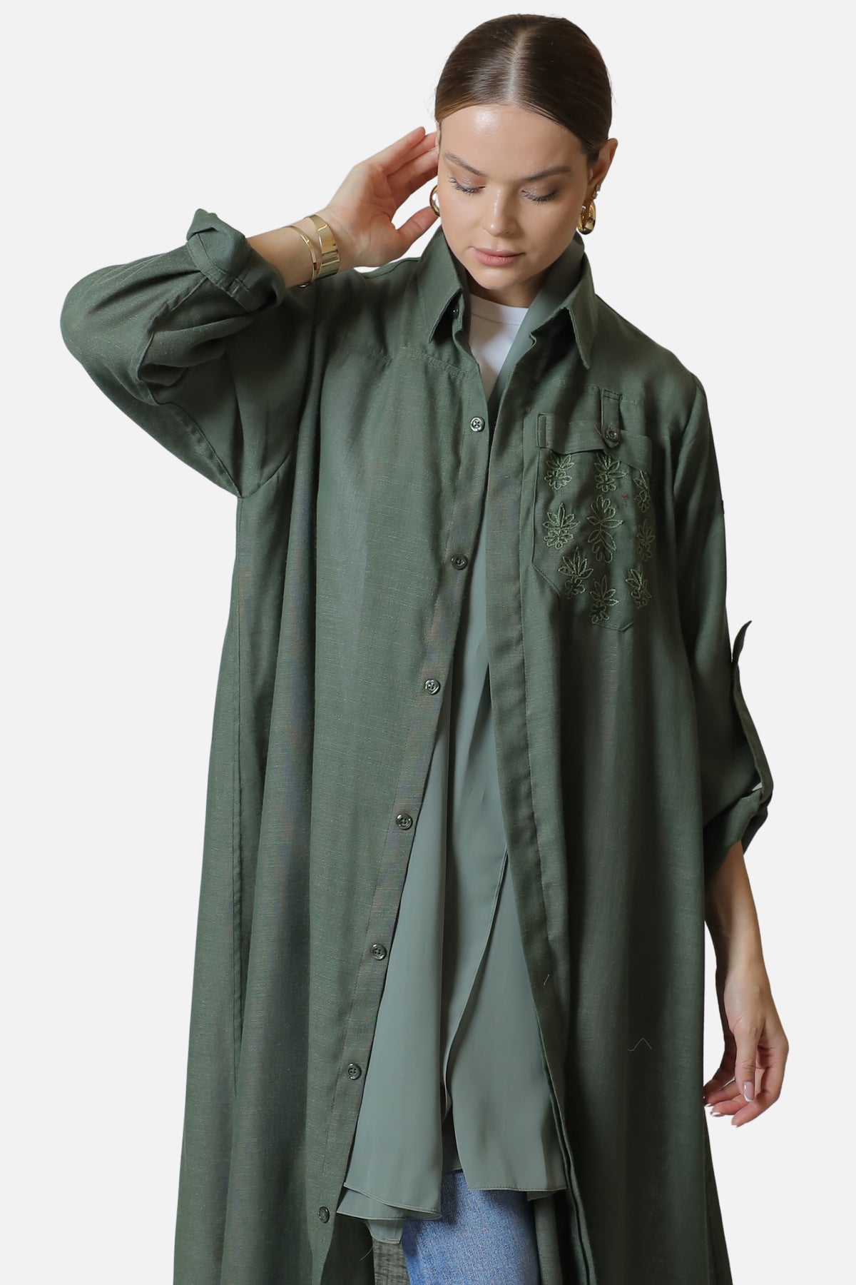 Green linen abaya — front detail with tonal chest embroidery