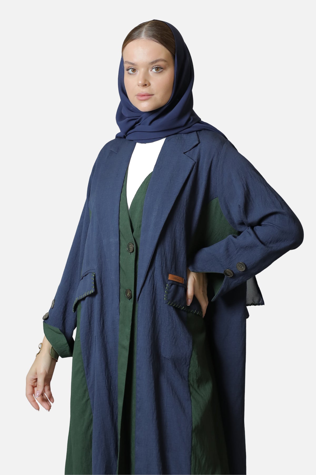 Blue and green linen abaya with two-tone details — front view