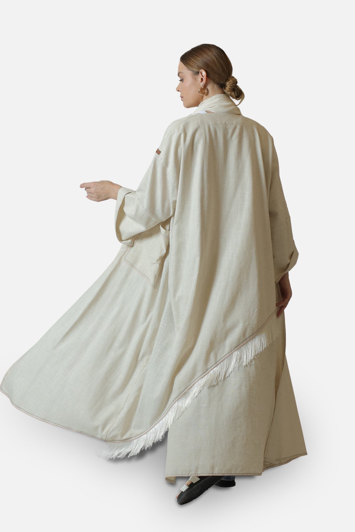 Ivory linen abaya with contrast stitch details — full-length back view