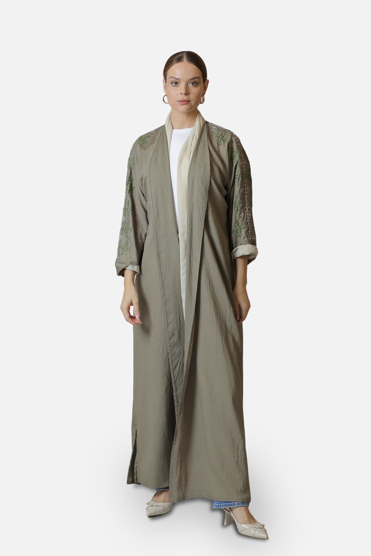 Full-length front view of the beige linen abaya with light green sleeve embroidery.