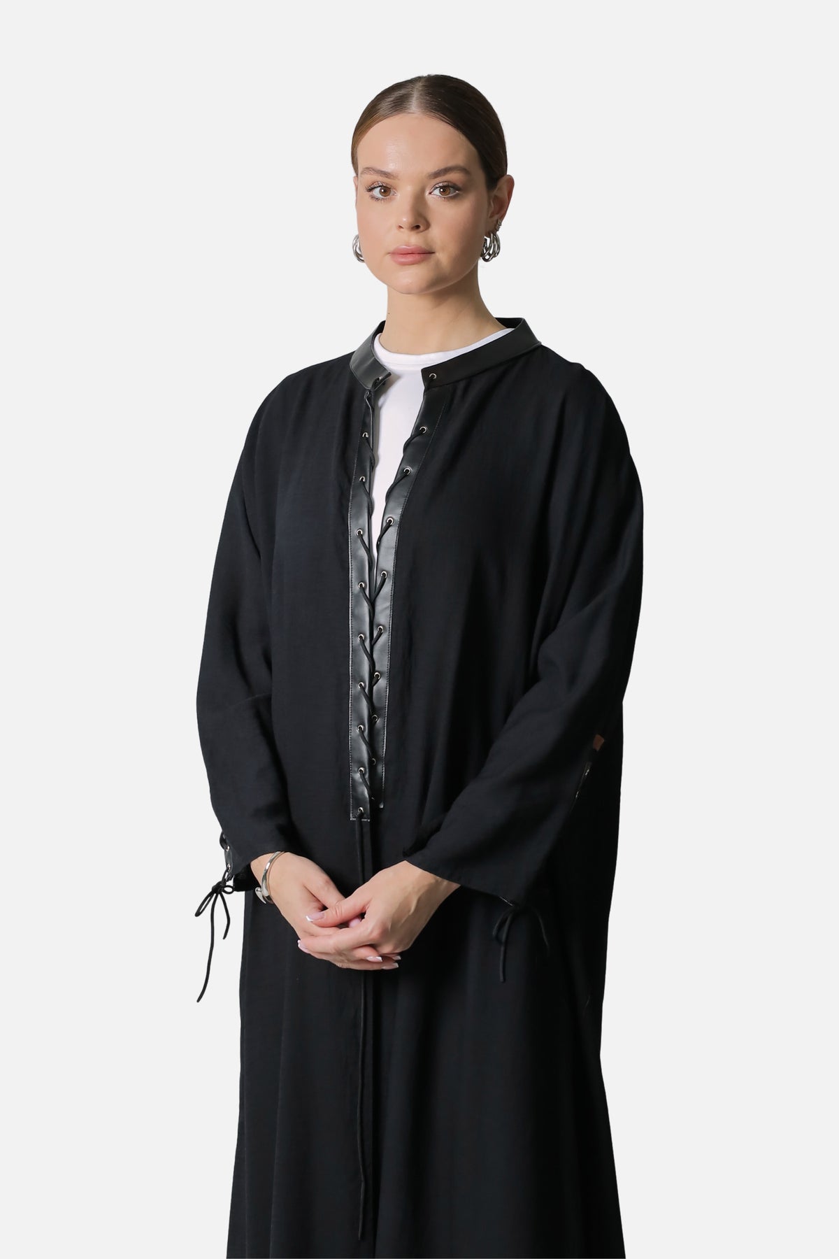 Black linen abaya fastened at the front, leather placket and laced sleeve cuffs