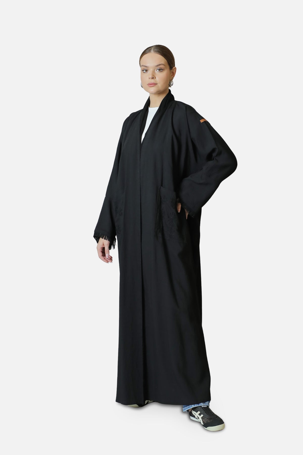 Black linen abaya worn open over a white top, full-length front view