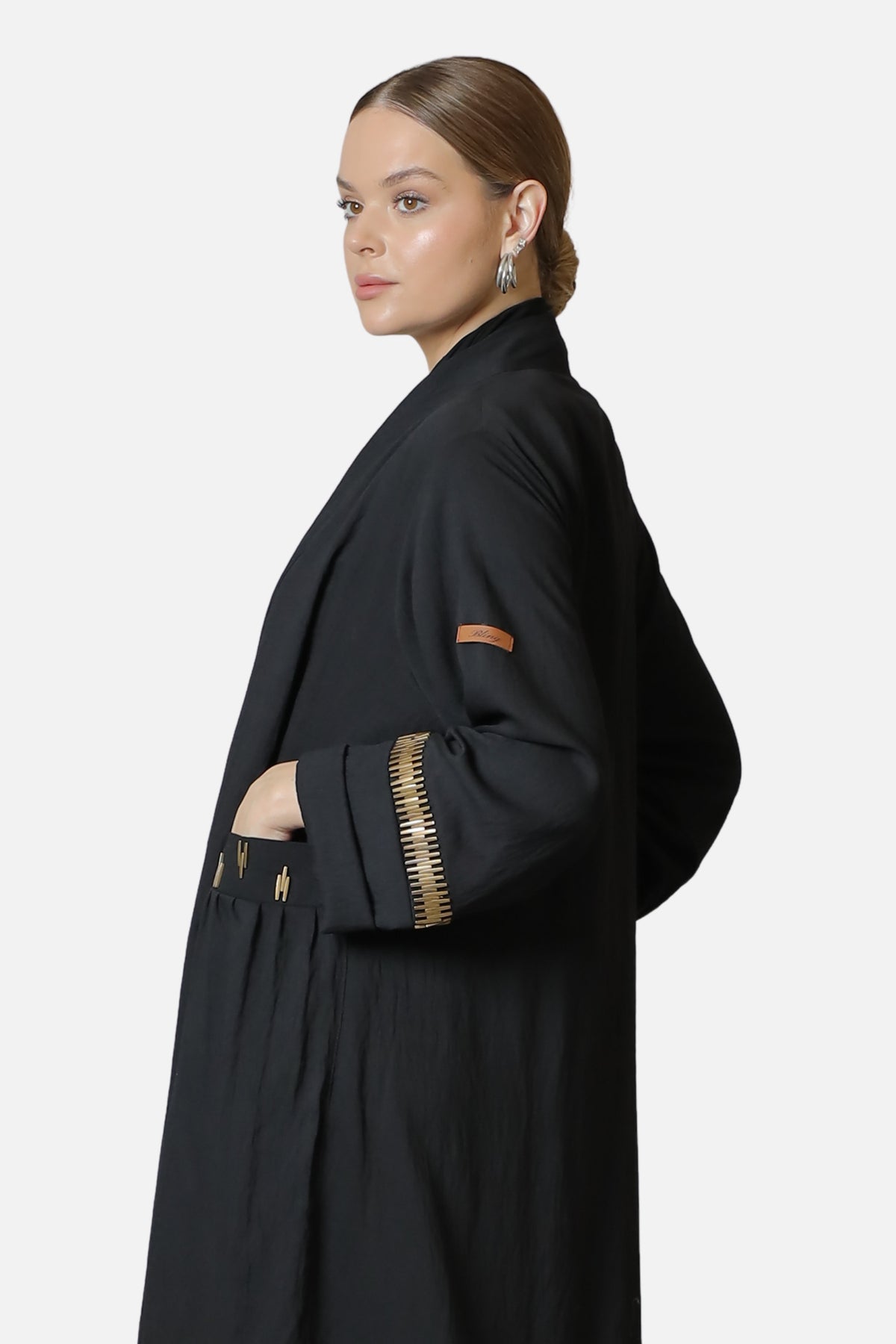 Black linen abaya — side view with gold-tone sleeve details