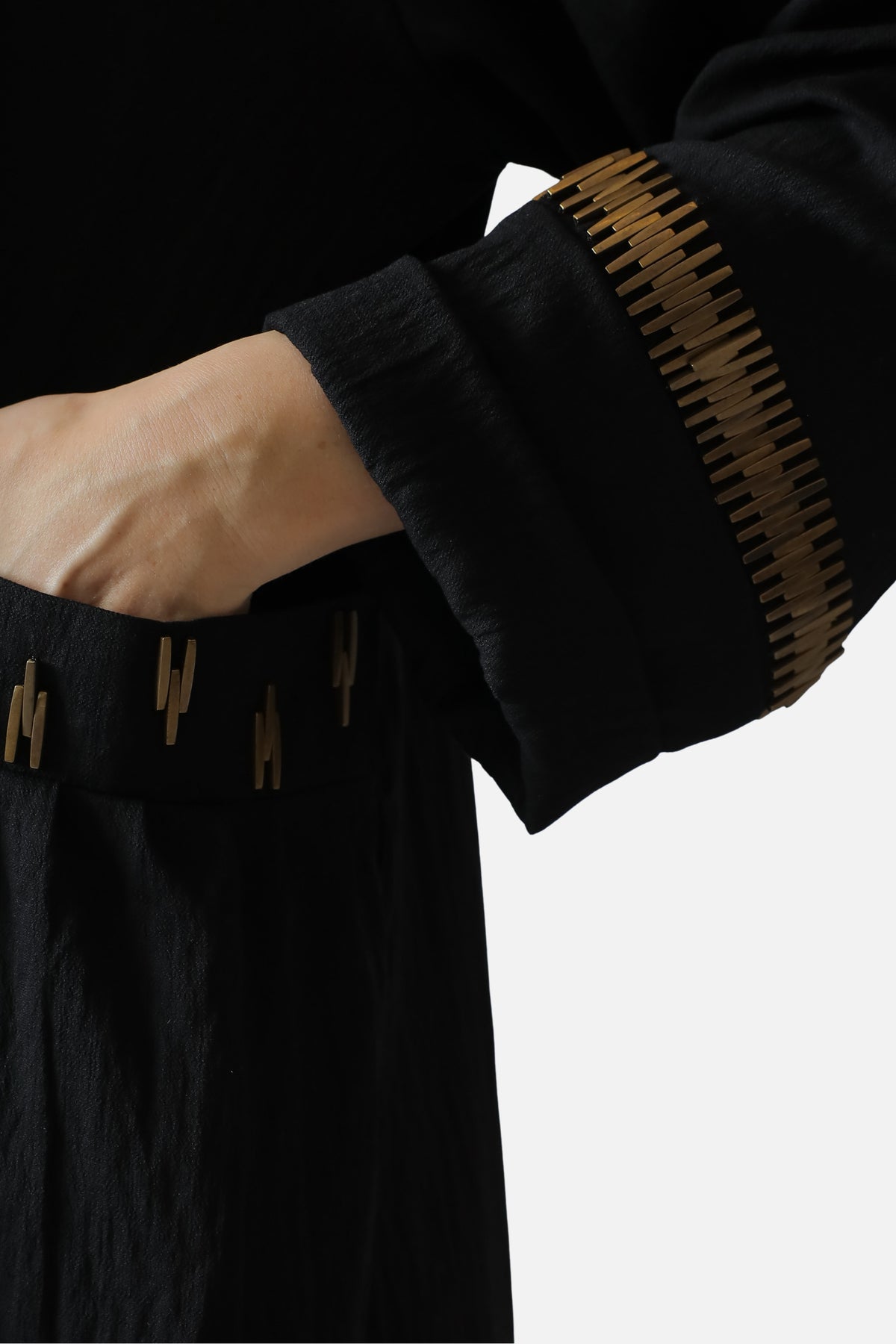 Black linen abaya — gold-tone sleeve detail close-up