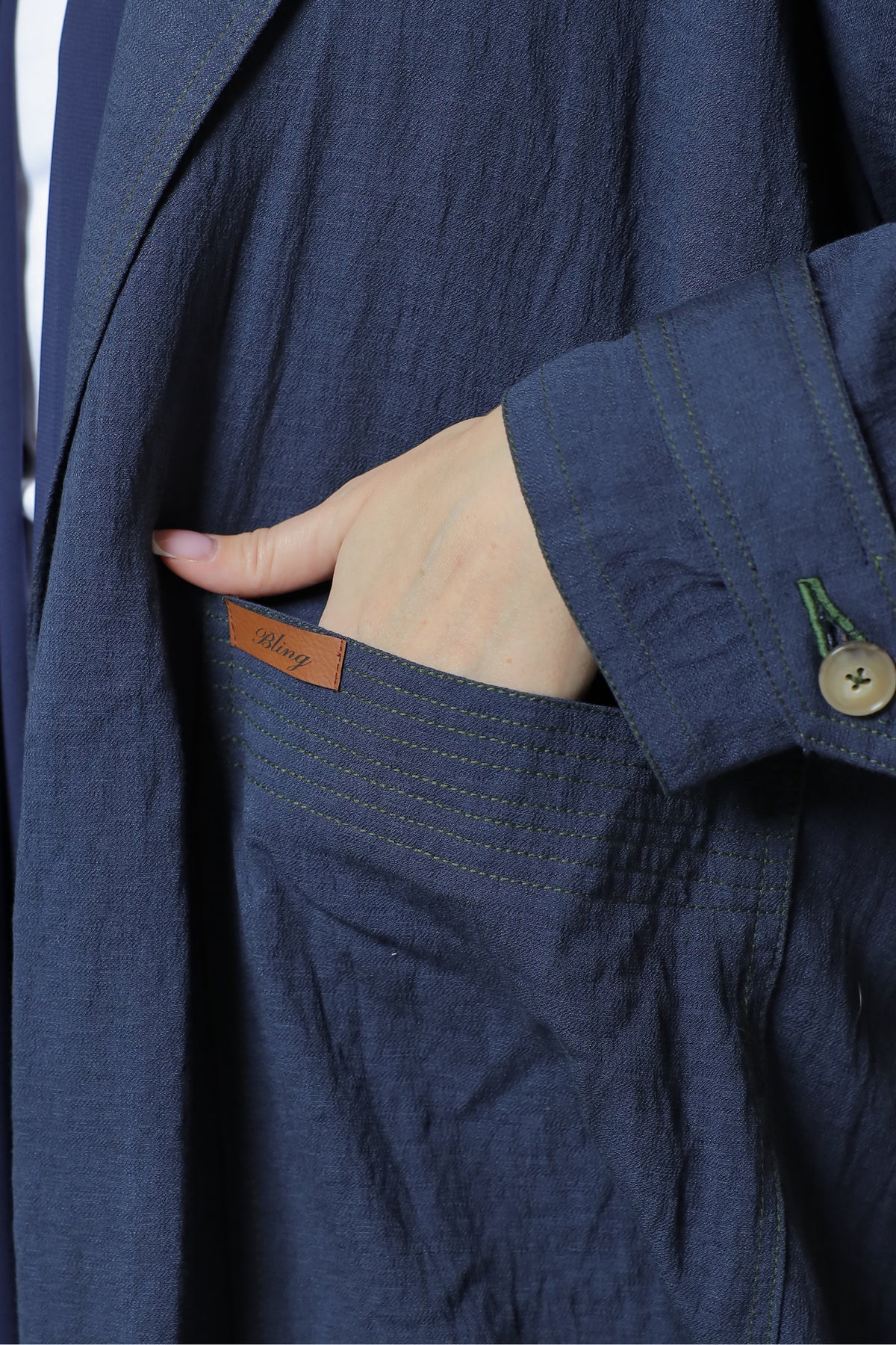 Navy linen abaya — fabric and contrast stitch detail