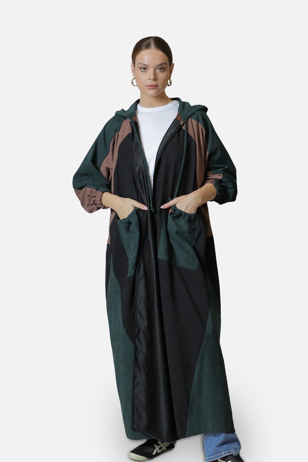Full-length front view of the dark green suede abaya with contrasting panels and hood.