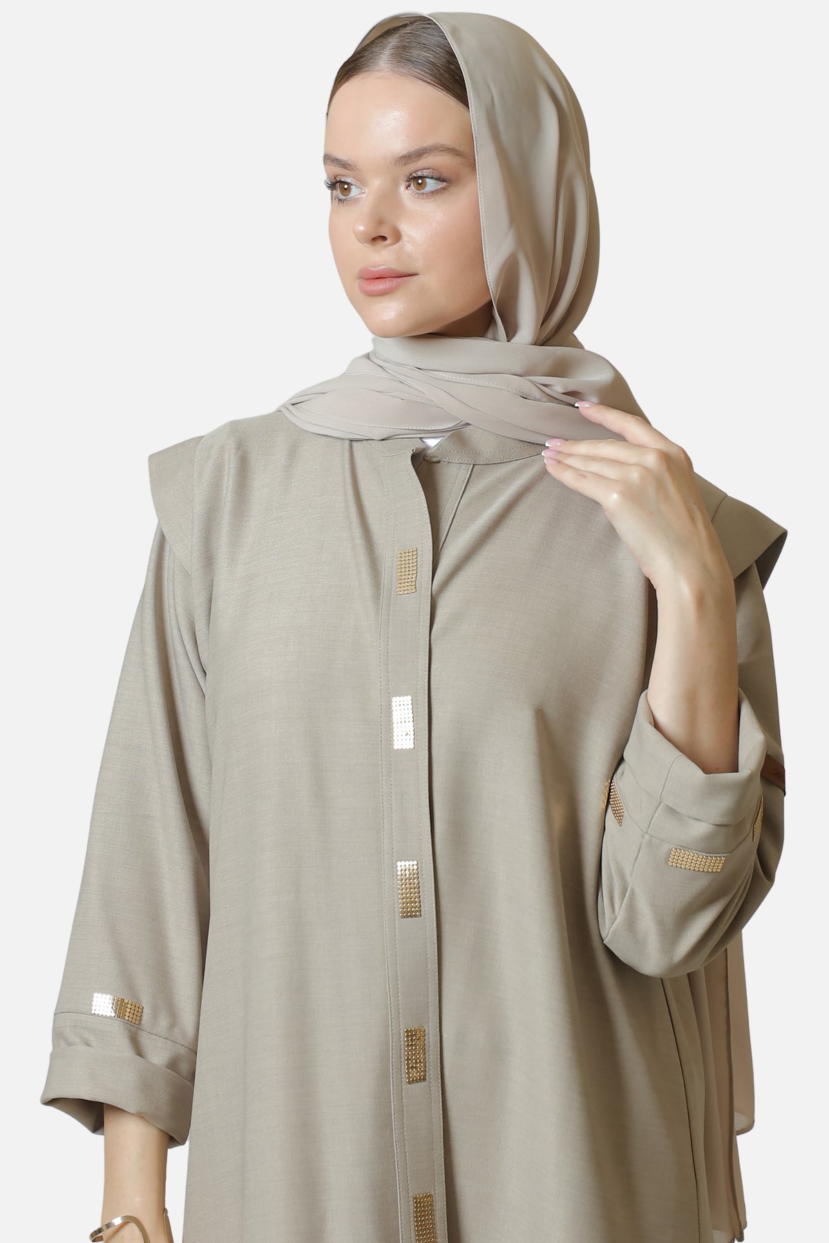 Beige cotton abaya with gold-tone details — front view