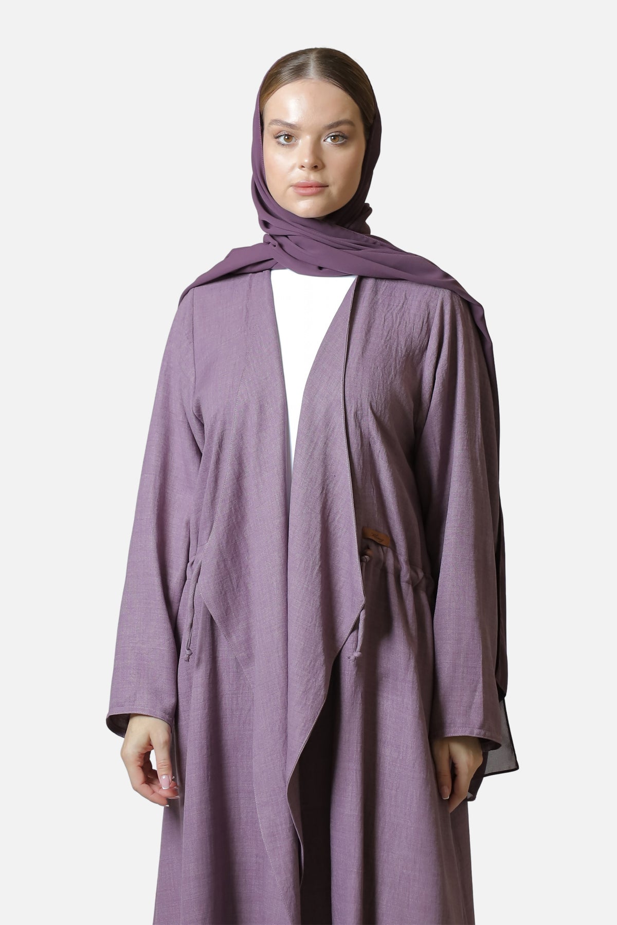 Front view of the purple cotton abaya showing its sleeves, side pockets, and fabric drape.