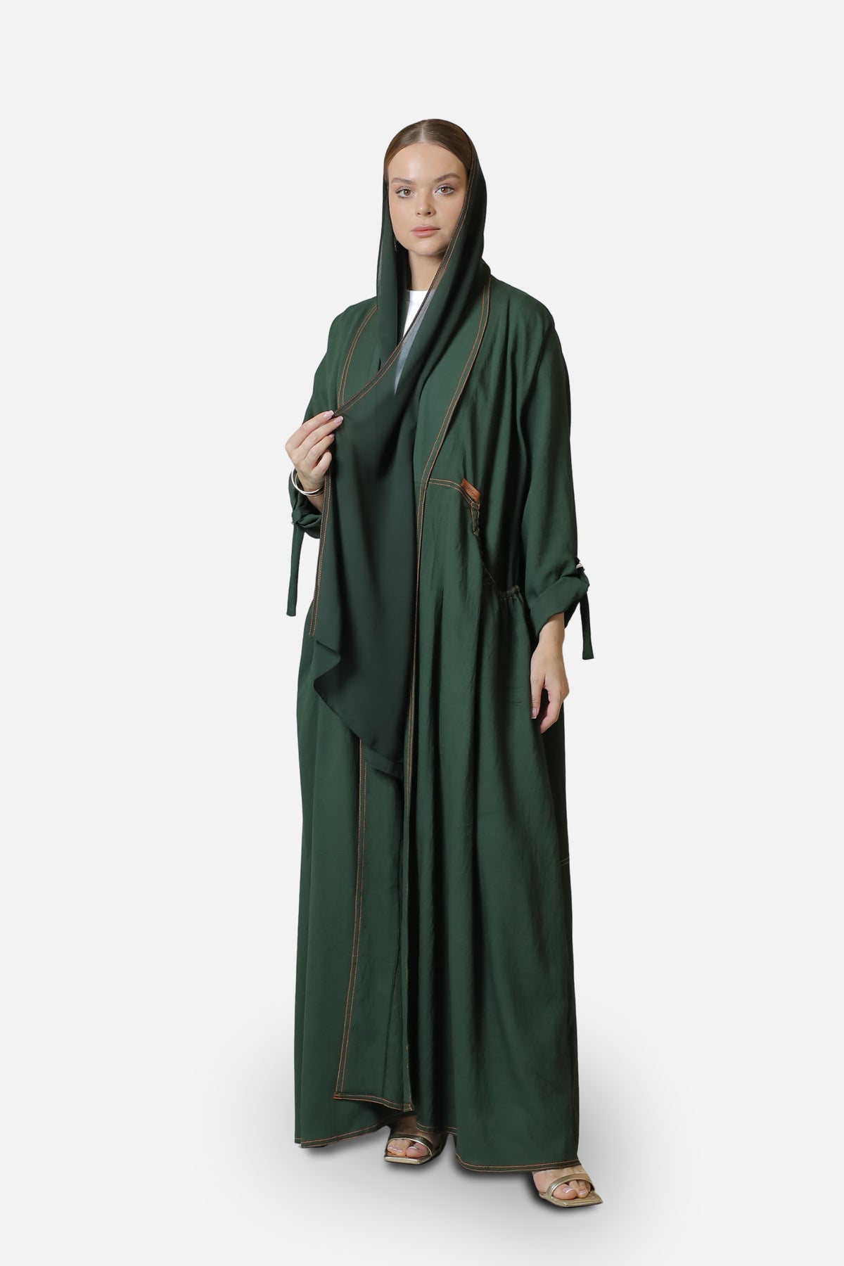 Full-length front view of the green linen abaya with contrast stitching along the edges.