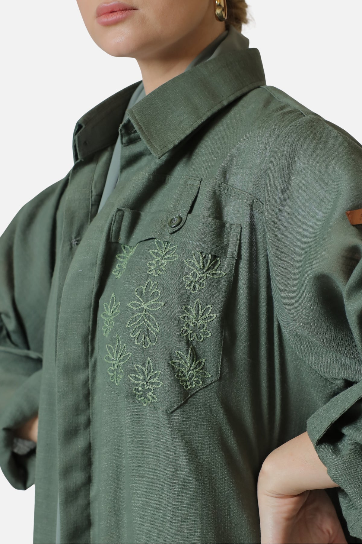 Green linen abaya — tonal chest embroidery close-up