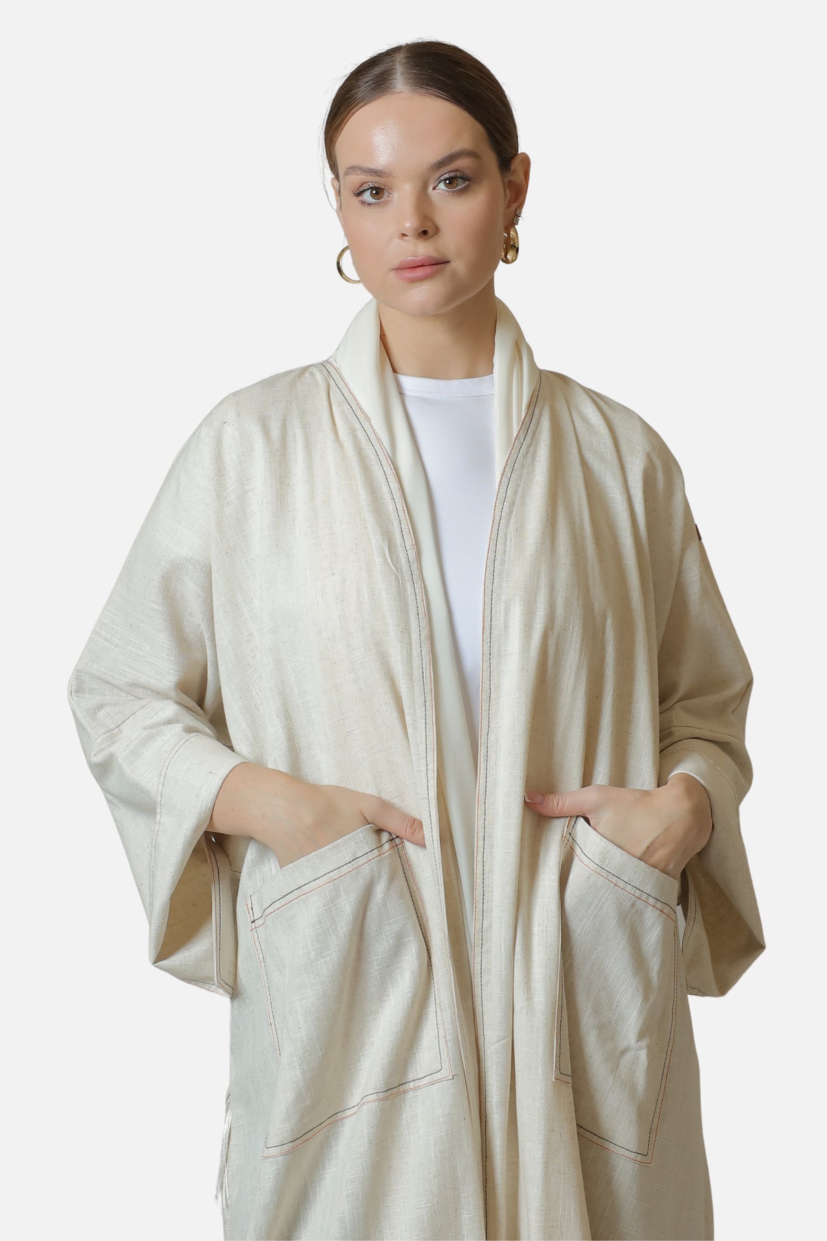 Ivory linen abaya with contrast stitch details — front view