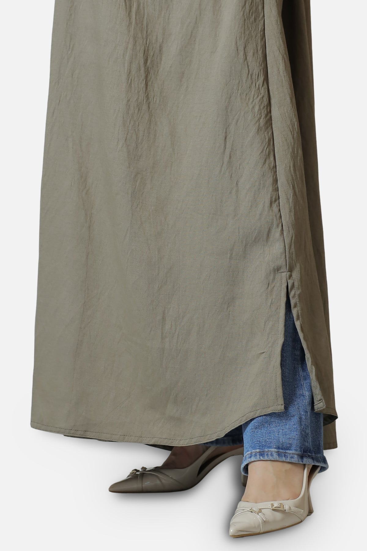 Detail of the lower front and hem of the beige linen abaya.