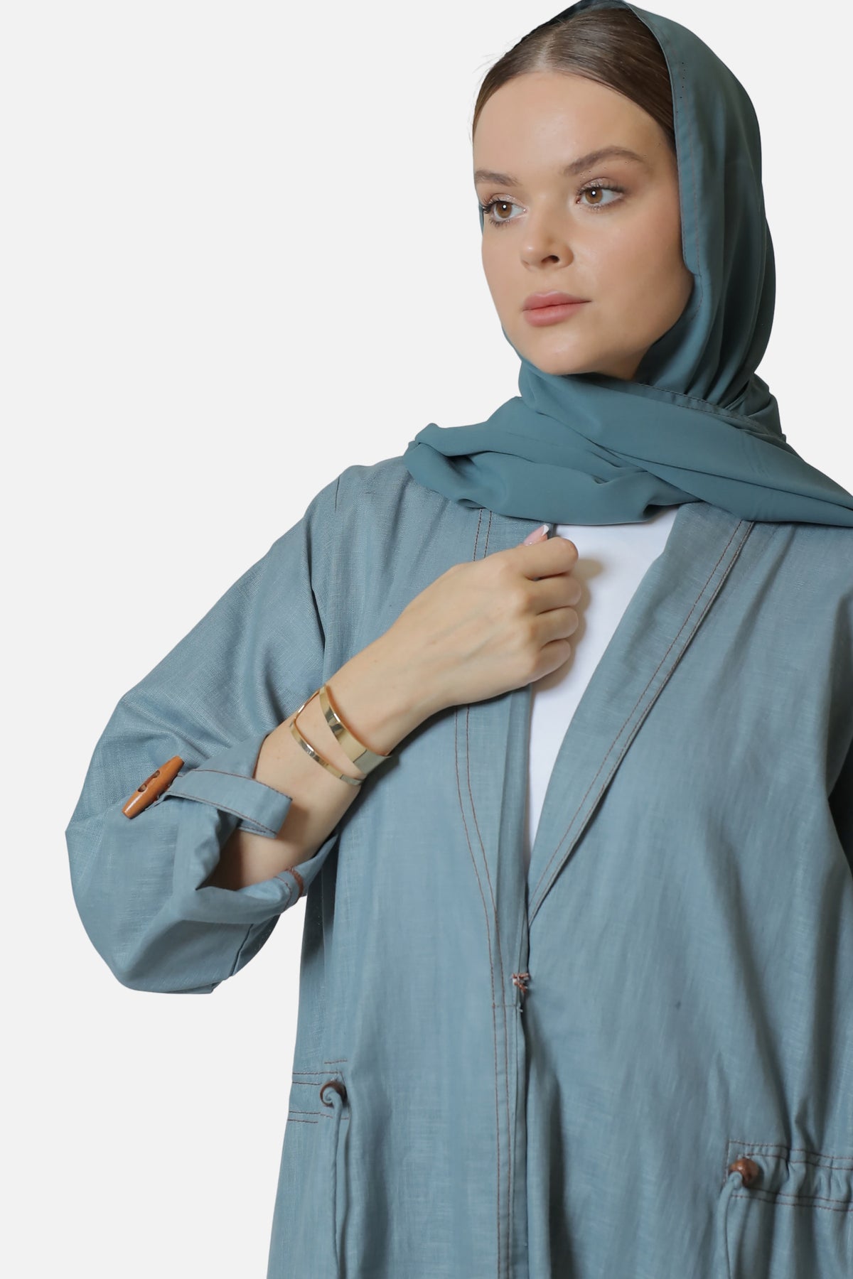 Blue-gray linen abaya with wooden button details, shown with a coordinating shaila.