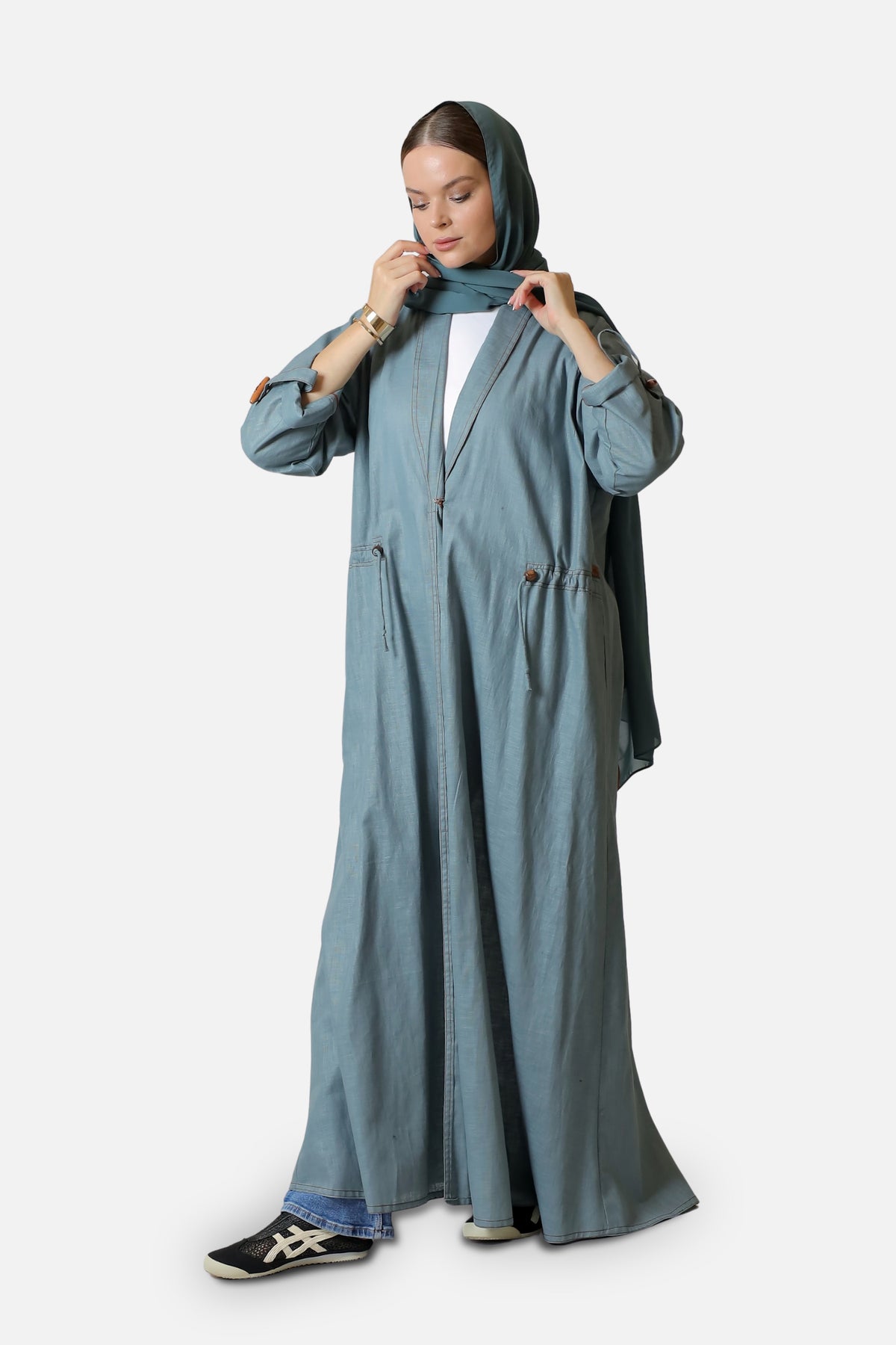 Full-length view of the blue-gray linen abaya with wooden button details.