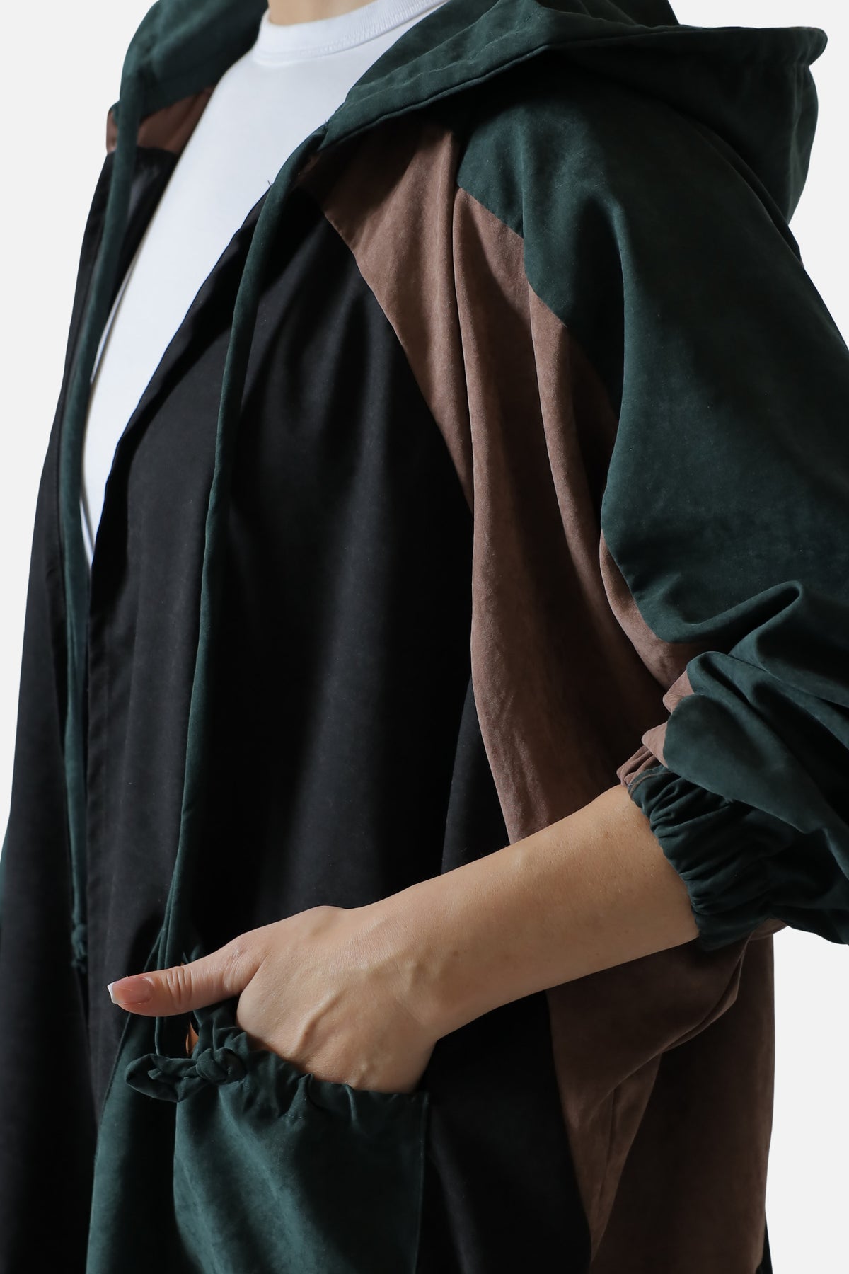 Detail of the gathered cuff and front pocket on the dark green suede abaya.